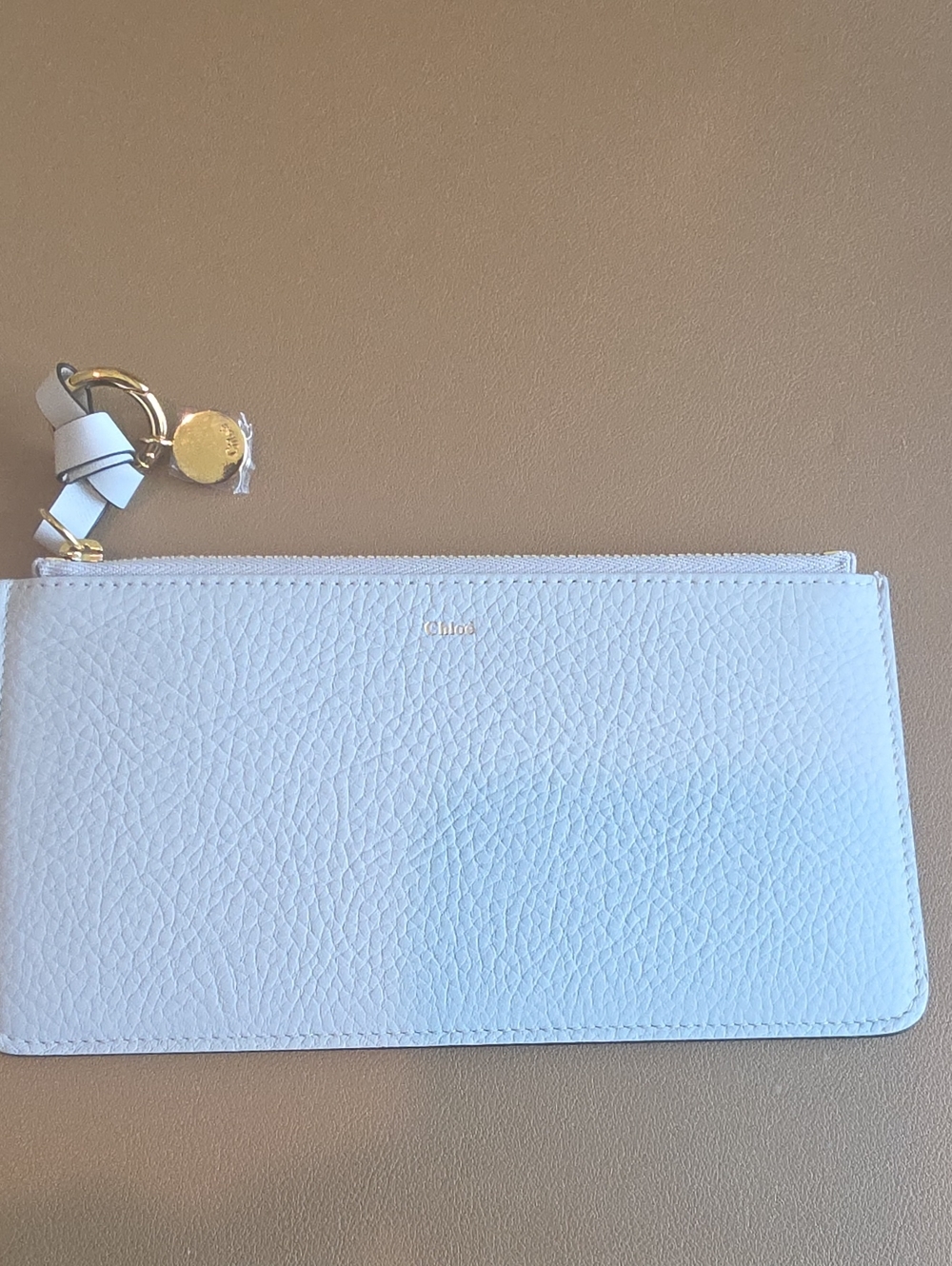Chloé Pale Gray Pebbled Leather Wristlet with Gold Charm. Never Used.